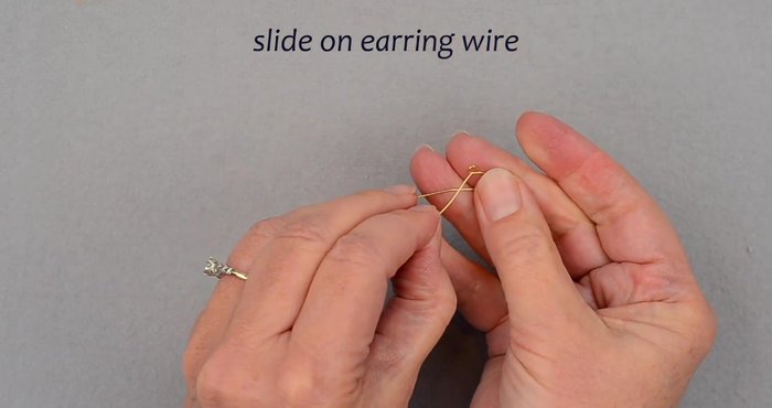 Attach earring wire: Slide the earring wire onto the final loop. Secure by wrapping the wire tail twice around the loop, then trim.