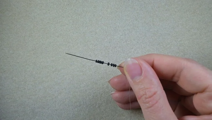 Create a knot at the end of the thread to secure the beads.