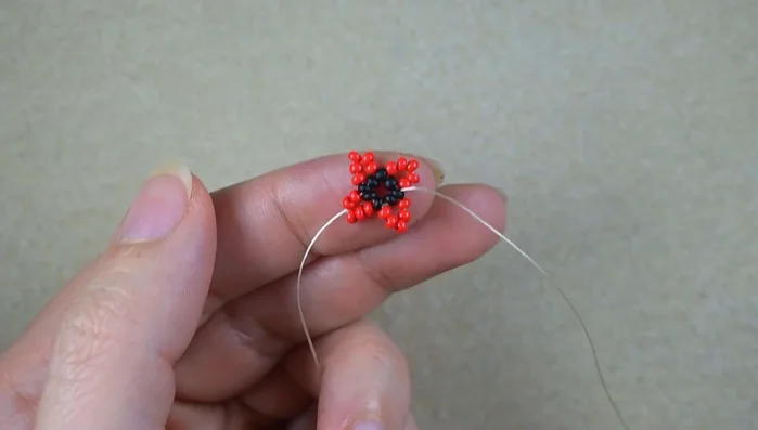 Repeat step 5 several times, adding three red beads each time and skipping the central bead.