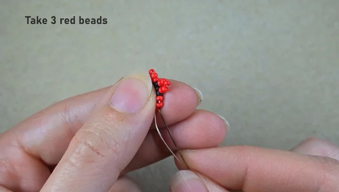 Repeat step 5 several times, adding three red beads each time and skipping the central bead.