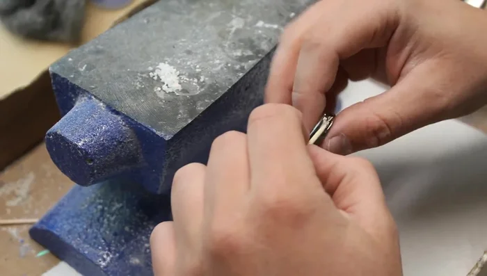 Individually place opal and lapis pieces into the wet CA glue using a toothpick.