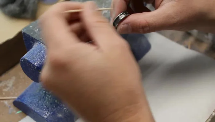 Individually place opal and lapis pieces into the wet CA glue using a toothpick.
