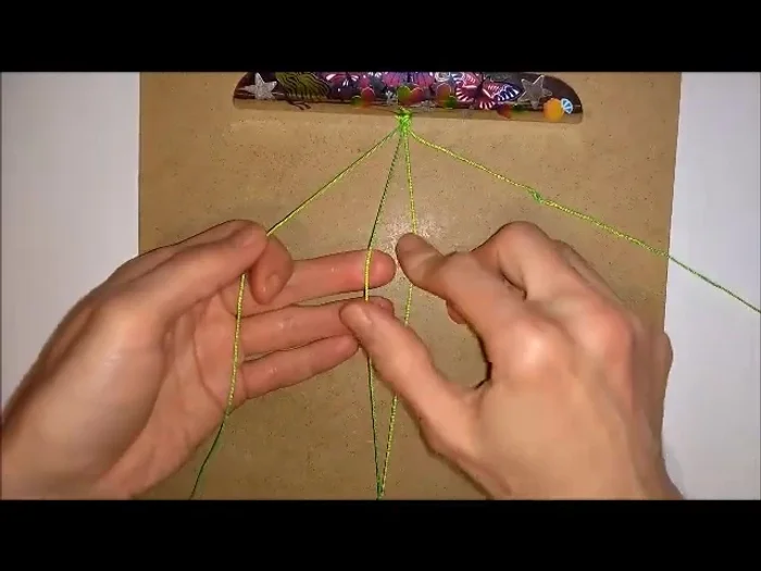 Push beads: After completing the knots on both sides, push the first bead into place.