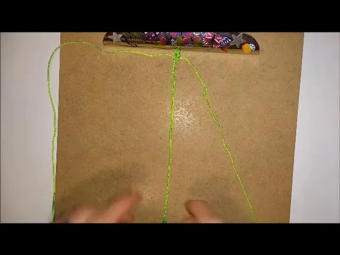 Push beads: After completing the knots on both sides, push the first bead into place.