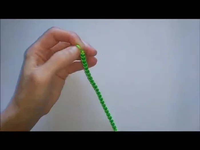 Final step: Use the loop to tie the bracelet on. Take one tail end and tie two patterns.
