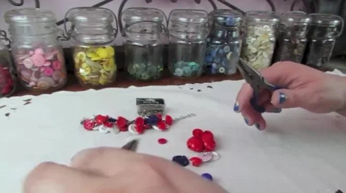 Attach the button (with its jump ring) to the chain, spacing it appropriately from other buttons. Close the jump ring securely.