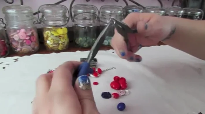 Attach the button (with its jump ring) to the chain, spacing it appropriately from other buttons. Close the jump ring securely.