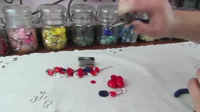 Attach the button (with its jump ring) to the chain, spacing it appropriately from other buttons. Close the jump ring securely.