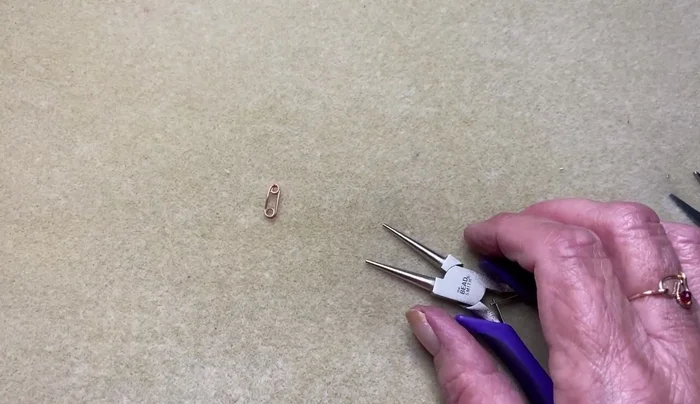 Connect the link to the chain using jump rings.