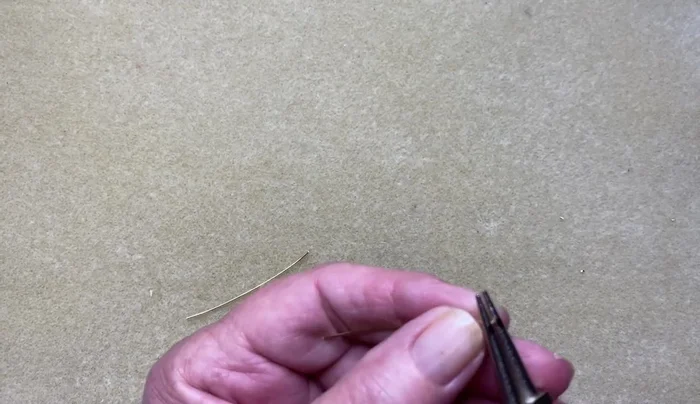 Using pliers, secure the overlap.