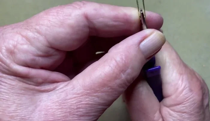 Using pliers, secure the overlap.