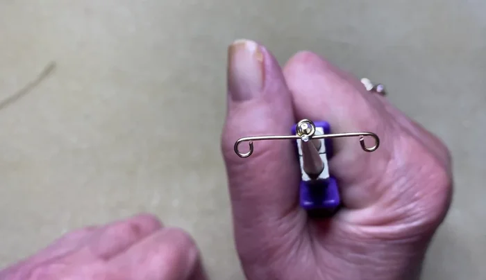 Using pliers, secure the overlap.