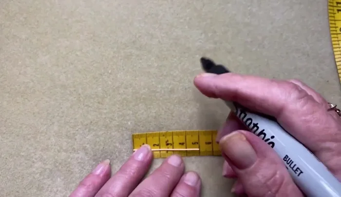 Create two loops at the 2.5cm mark, ensuring loops face each other.