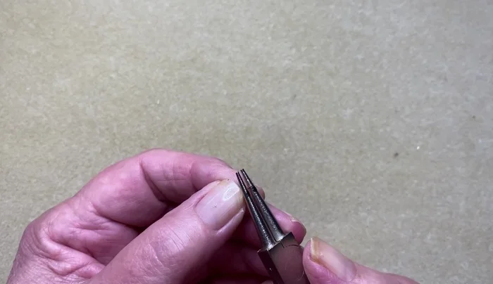 Create two loops at the 2.5cm mark, ensuring loops face each other.