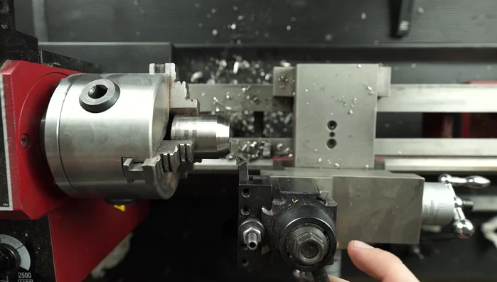 Refine the titanium ring edge on the lathe to ensure a proper fit with the koa wood.