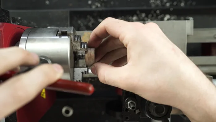 Machine the koa wood on the lathe to achieve the desired inner diameter for a snug fit with the titanium.