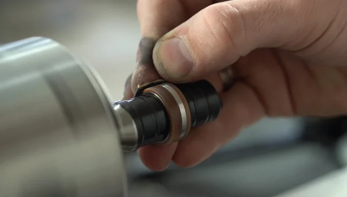 Remove excess CA adhesive from the titanium using a razor blade.