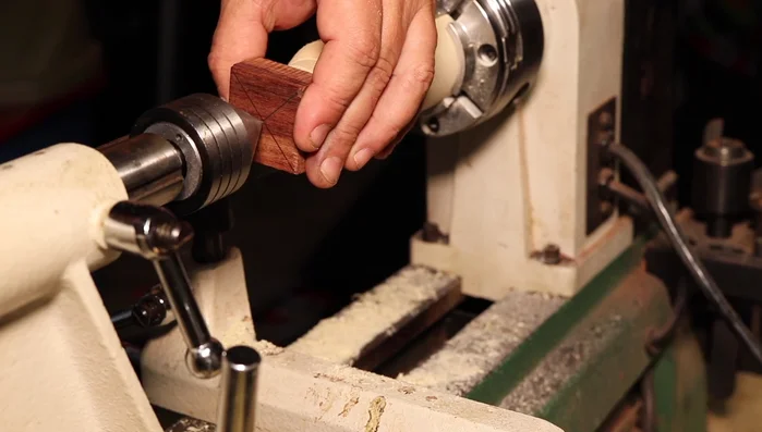 Center the blank on the lathe and turn it round.