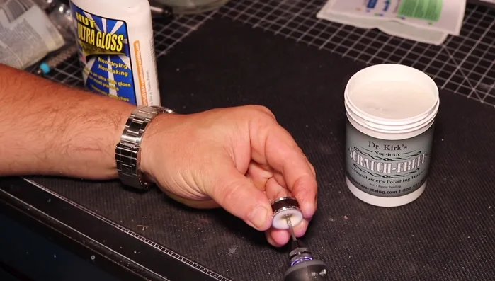 Polish the inside of the ring using a Dremel wheel and plastic scratch-free polish.