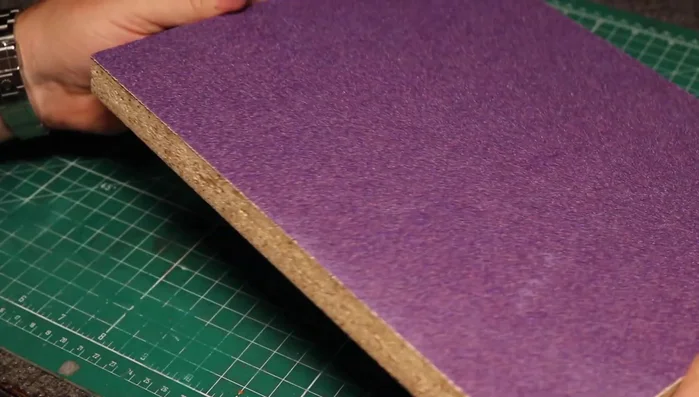 Prepare the East India Rosewood blank. Sand one side flat using sandpaper attached to a melamine base.