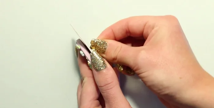 Attach finished badges to card stock backings mounted on thicker cardboard for sturdiness.