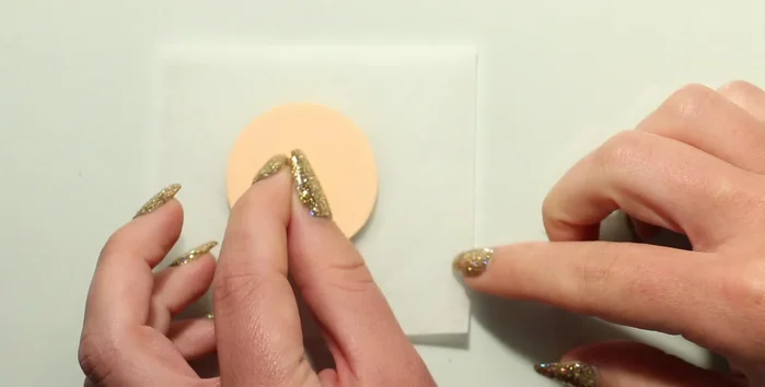 Create indentations for gold backings and remove excess clay.