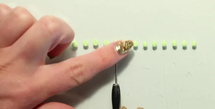 Create small clay decorations (leaves, flowers, animals).