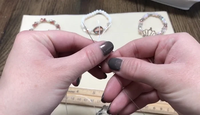 Switch sides: Remove the needle and attach it to the other side of the bracelet (leaving some tail on the previous side). String the remaining beads onto this side.