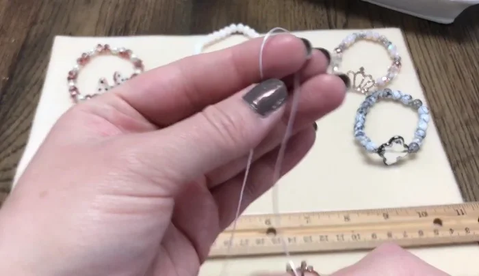 Prepare your materials: Cut two 16-inch pieces of stretch cord. Choose beads large enough for the cord to pass through.