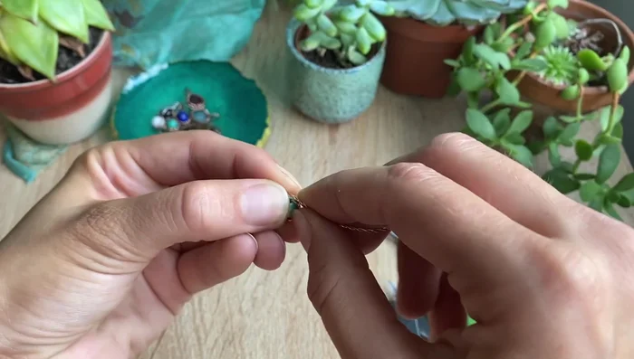 Gently curve the wire around the bead to shape it.