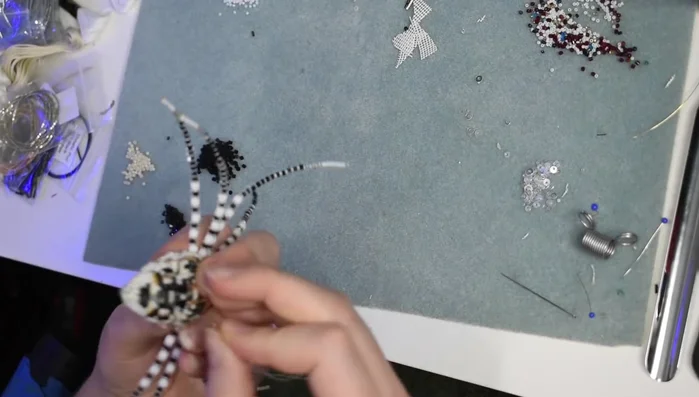 Sew on the pin back.