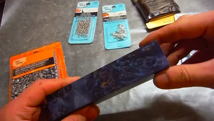 Sand the wood piece until it's shaped into a bead.