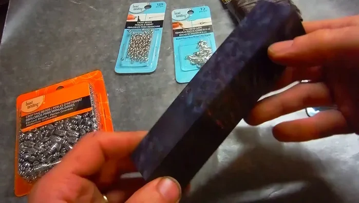 Sand the wood piece until it's shaped into a bead.