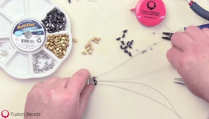 Continue the pattern: 1 fire polish bead on the first strand, bronze/gold half-moon on strands 2 & 3 (alternating holes), 1 fire polish bead on strand 4. Repeat with hematite, then fire polish, etc.