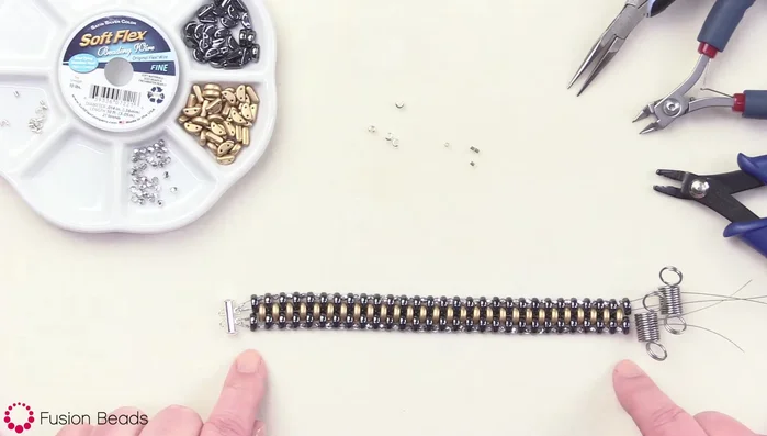 Attach the open ends to the other end of the 2-bar clasp. Use a bead stopper on each end to keep the wires separated while attaching.