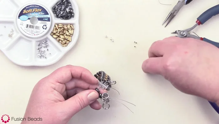 Cover the crimp beads with crimp bead covers and crimp to secure.