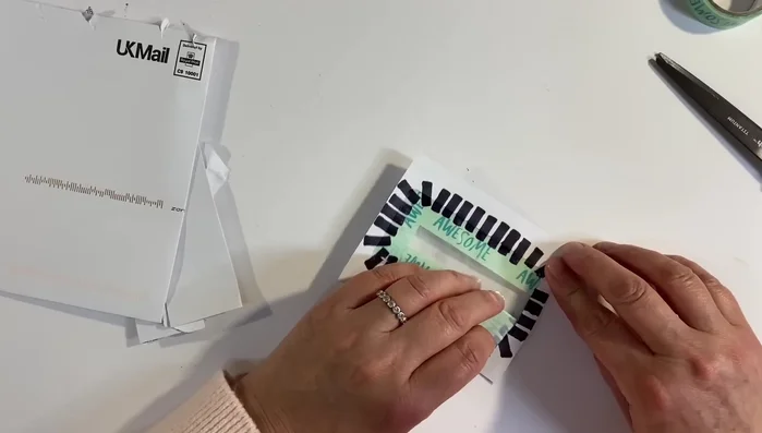 Peel away the washi tape from the inside of the envelope.