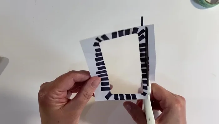 Cut around the outside of the remaining envelope piece, creating a frame for the flowers.