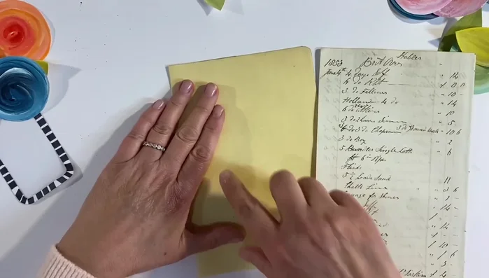 Distress the edges of the vintage ledger paper using distress ink.