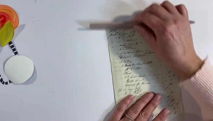 Distress the edges of the vintage ledger paper using distress ink.