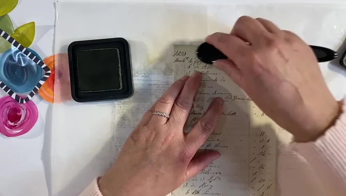 Distress the edges of the vintage ledger paper using distress ink.