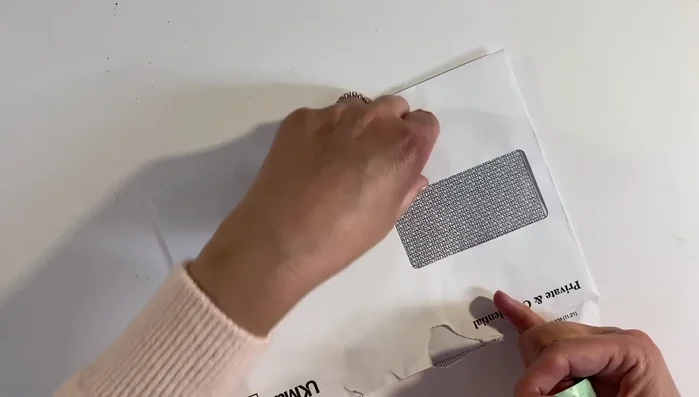Peel away the washi tape from the inside of the envelope.