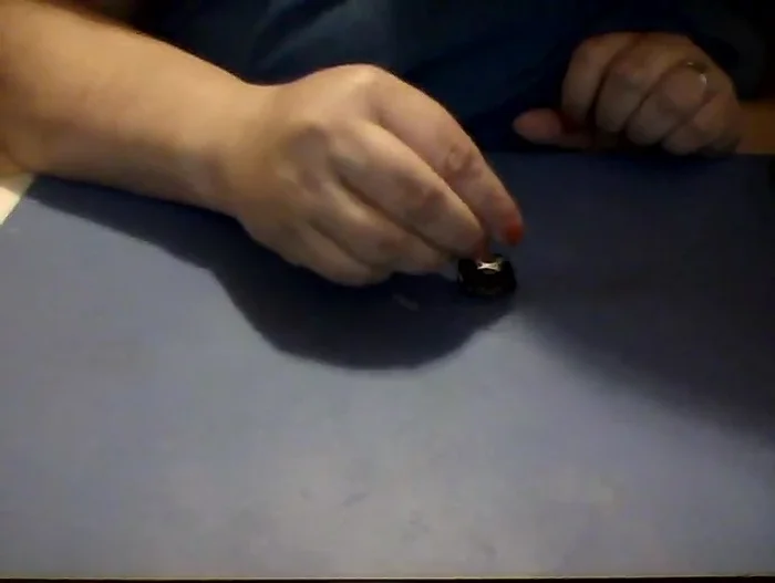 Once melted, carefully press the glass piece onto the molten bail bond, ensuring it's centered.