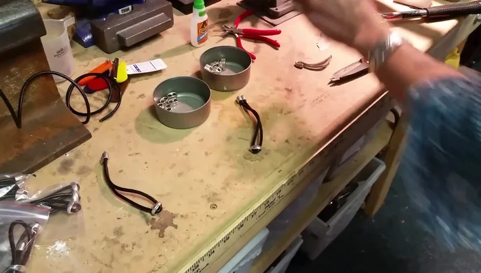 Assemble the bracelet: Attach one end of the leather cord to the silverware using an oval jump ring. Close the jump ring and spin it to hide the seam.