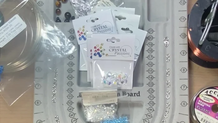 Prepare beads: Lay out the beads in an alternating pattern of two 8mm and two 6mm beads. Alternating colors (clear and aquamarine).