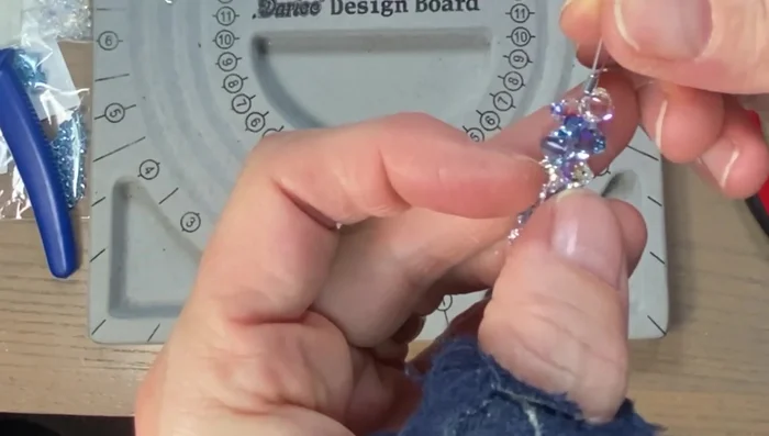 Crimp the wire: Once all the beads are strung, thread the wire back through the crimp bead and crimp it tightly using crimping pliers.