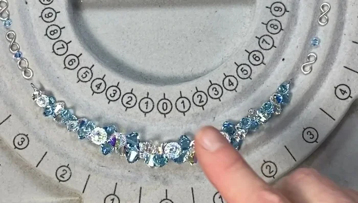 Create bead links: Cut 20-gauge wire into pieces. Create loops and attach 4mm crystals to make bead links, creating a total of 12.