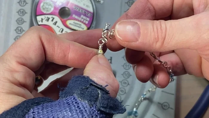 Finishing touches: Add a small wrapped loop with a crystal on the other end to complete the necklace. Trim any excess wire, and ensure all edges are smooth to prevent irritation.