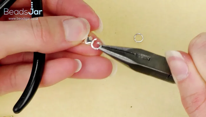 Attach a jump ring to the lobster clasp. Attach another jump ring to the other end of the bracelet.