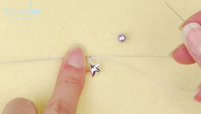 Thread both wire strands through a Preciosa bead. Repeat steps 2 and 3 until the desired bracelet length (7.5 inches including clasp) is reached. Ensure the last bead is a Preciosa, not a pearl.